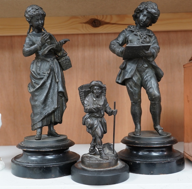 A Victorian bronze figure of a man carrying basket and a pair spelter figures, 32cm. Condition - fair to good, a little worn, particularly bases